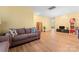 Open living area with modern wood-look flooring, comfortable sofa, and a view into an adjacent space at 1911 Savannah Hills Dr, Matthews, NC 28105