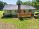 Aerial view of home with a wooden deck, chimney, and surrounding foliage at 2011 20Th Street Ne Pl, Hickory, NC 28601