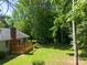Spacious backyard featuring a wood deck, lush greenery, and mature trees, creating a serene outdoor space at 2011 20Th Street Ne Pl, Hickory, NC 28601