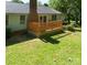 View of the wood deck and backyard of a light-green house with a chimney at 2011 20Th Street Ne Pl, Hickory, NC 28601
