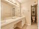 Well-lit bathroom with large mirror, double sinks, and light colored tile floor at 2011 20Th Street Ne Pl, Hickory, NC 28601