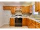 Kitchen with wooden cabinets, brick style backsplash, and modern appliances at 2011 20Th Street Ne Pl, Hickory, NC 28601