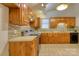 Kitchen with wooden cabinets, brick style backsplash, and modern appliances at 2011 20Th Street Ne Pl, Hickory, NC 28601