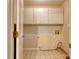 Functional laundry room with overhead cabinets and tile flooring for easy maintenance at 2011 20Th Street Ne Pl, Hickory, NC 28601
