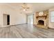 Spacious living room with a stone fireplace, a ceiling fan, and access to the outdoor deck at 2011 20Th Street Ne Pl, Hickory, NC 28601