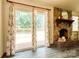 View of the living room with sliding glass doors leading to an outdoor deck and a cozy stone fireplace at 2011 20Th Street Ne Pl, Hickory, NC 28601