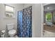 Bathroom with a toilet, shower with a decorative curtain and a view of outdoors at 20307 Creek Bend Edge Ct # 10, Matthews, NC 28105