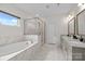 Elegant bathroom features a soaking tub, glass shower, and dual sink vanity at 20307 Creek Bend Edge Ct # 10, Matthews, NC 28105