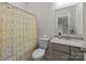 Bathroom with a toilet, sink, decorative shower curtain and neutral paint at 20307 Creek Bend Edge Ct # 10, Matthews, NC 28105