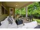 Inviting covered patio features comfortable seating, stylish decor, and tranquil views of the lush backyard at 20307 Creek Bend Edge Ct # 10, Matthews, NC 28105