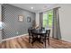 Charming dining area with geometric wallpaper, wood floors, and natural light at 20307 Creek Bend Edge Ct # 10, Matthews, NC 28105