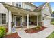 Inviting front porch with stone accents and a cozy seating area, perfect for relaxing outdoors at 20307 Creek Bend Edge Ct # 10, Matthews, NC 28105