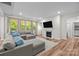 Spacious living room with a fireplace, large windows, hardwood floors, and a comfortable sectional sofa at 20307 Creek Bend Edge Ct # 10, Matthews, NC 28105