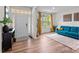 Bright living room featuring hardwood floors, a large window, and a comfortable blue sofa at 20307 Creek Bend Edge Ct # 10, Matthews, NC 28105