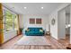 Living room with a large window, stylish decor, and hardwood floors, creating a welcoming atmosphere at 20307 Creek Bend Edge Ct # 10, Matthews, NC 28105
