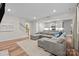 Inviting living room showcasing a gray sectional sofa and seamless transition to the kitchen at 20307 Creek Bend Edge Ct # 10, Matthews, NC 28105
