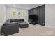 Cozy living room with comfortable seating, a large TV, and modern wall accents at 20307 Creek Bend Edge Ct # 10, Matthews, NC 28105