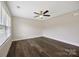 Empty bedroom featuring hardwood floors, a ceiling fan, and a bright window at 209 S Gregory St # 3, Lancaster, SC 29720