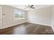 Spacious bedroom with hardwood floors, a ceiling fan, and a large window offering ample light at 209 S Gregory St # 3, Lancaster, SC 29720