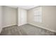 A bedroom featuring carpet, a window, and a door at 209 S Gregory St # 3, Lancaster, SC 29720
