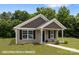 Well-maintained single-story home featuring tidy landscaping and attractive neutral siding at 209 S Gregory St # 3, Lancaster, SC 29720