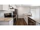 Stylish kitchen boasts stainless steel appliances, granite countertops, and wood flooring at 209 S Gregory St # 3, Lancaster, SC 29720