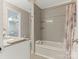 Well-lit bathroom featuring a tub with tile surround and built in shelves at 212 W 10Th St # 3, Charlotte, NC 28202