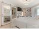 Spacious bedroom featuring a TV, a walk-in closet, and a view into the en-suite bathroom at 212 W 10Th St # 3, Charlotte, NC 28202