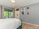 Airy bedroom with balcony access, built in shelving, and hardwood floors at 212 W 10Th St # 3, Charlotte, NC 28202