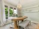 Bright dining room with chandelier, decorative shelving, and outdoor views at 212 W 10Th St # 3, Charlotte, NC 28202