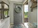 Inviting foyer with wreath and views into the living room and outdoor balcony at 212 W 10Th St # 3, Charlotte, NC 28202