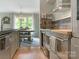 Open concept kitchen with stainless steel appliances, eat in area and views to dining room at 212 W 10Th St # 3, Charlotte, NC 28202