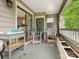 Cozy covered patio with outdoor seating and a view into the house with natural light at 212 W 10Th St # 3, Charlotte, NC 28202