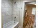 Bathroom boasting marble tiled walls, sleek fixtures, and a view into the kitchen at 216 N Vance St, Gastonia, NC 28052