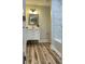 Bright bathroom with marble tiled wall, modern vanity, and new wood flooring at 216 N Vance St, Gastonia, NC 28052