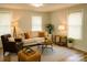 Inviting living room with neutral tones, comfortable seating, and ample natural light from two large windows at 216 N Vance St, Gastonia, NC 28052
