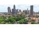 Aerial view of city skyline with surrounding neighborhood and lush green trees and blue skies at 224 N Poplar St # 24, Charlotte, NC 28202
