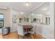 Bright dining room with hardwood floors, mirrors and neutral paint at 224 N Poplar St # 24, Charlotte, NC 28202