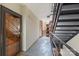 Hallway with door 24, stairs with black railings, and view of outside brick building at 224 N Poplar St # 24, Charlotte, NC 28202