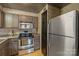 Traditional kitchen features wood cabinets, stainless steel appliances, and neutral countertops and backsplash at 224 N Poplar St # 24, Charlotte, NC 28202