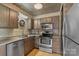 Traditional kitchen with stainless steel appliances, wooden cabinets, and decorative ceiling at 224 N Poplar St # 24, Charlotte, NC 28202
