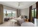 Comfortable bedroom features a bay window, soft lighting, and plush bedding at 224 N Poplar St # 24, Charlotte, NC 28202