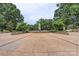 Beautiful entrance to Fourth Ward Park with mature trees and sculpted bushes at 224 N Poplar St # 24, Charlotte, NC 28202