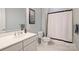 Cozy bathroom with traditional fixtures, a neutral color scheme, a shower and tub combo, and soft lighting at 229 N Church St # 204, Charlotte, NC 28202