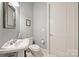 Charming powder room with a pedestal sink, classic fixtures, and a clean, inviting design at 229 N Church St # 204, Charlotte, NC 28202