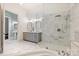 Luxurious bathroom featuring a glass enclosed shower, soaking tub and double vanity with grey cabinets at 229 N Church St # 204, Charlotte, NC 28202