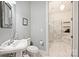 Elegant bathroom featuring marble floors, a pedestal sink, and a separate shower and tub area at 229 N Church St # 204, Charlotte, NC 28202