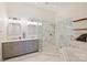 Elegant bathroom featuring double vanity, marble finishes, a glass-enclosed shower, and a soaking tub at 229 N Church St # 204, Charlotte, NC 28202