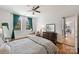 Comfortable bedroom showcasing hardwood floors, a ceiling fan, natural light, and a cozy seating area at 229 N Church St # 204, Charlotte, NC 28202