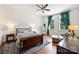 Cozy bedroom with hardwood floors, ceiling fan, natural lighting, and neutral tones throughout at 229 N Church St # 204, Charlotte, NC 28202